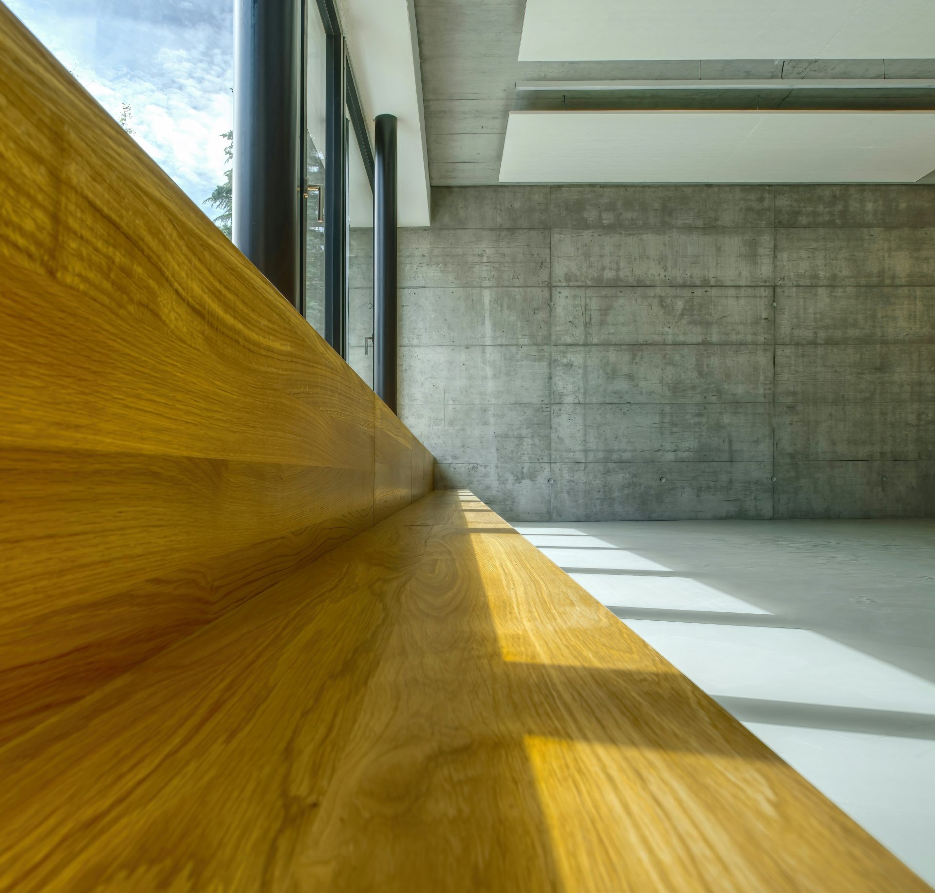 brown wooden table near white wall